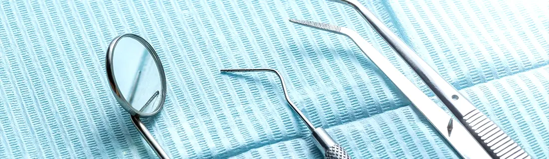 Dental Exam Tools Laid Out Neatly On Light Blue Towel