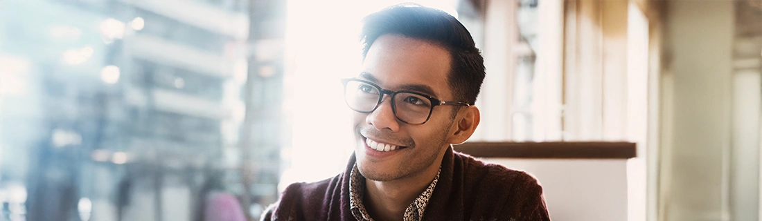 Man With Glasses Smiling In Cafe